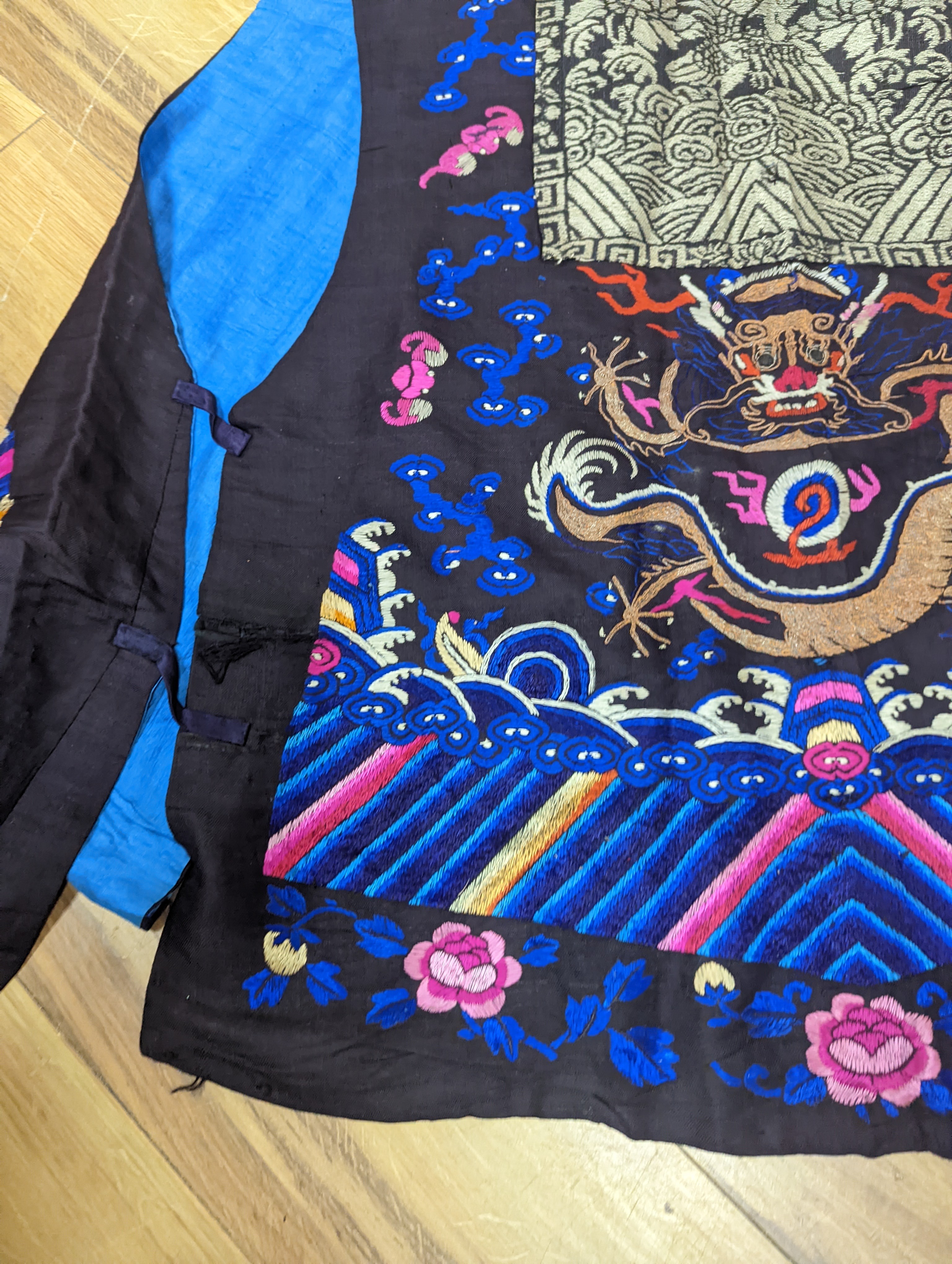 A 1920's Chinese dragon embroidered waistcoat, a cream silk drawn thread dress and a silk crepe black and patterned reversible kimono (3 items).